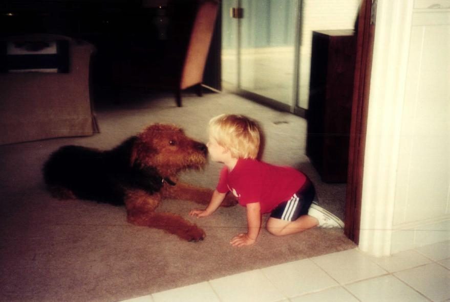 John as a child with Barney the Airedale Terrier who inspired Barney and Boots